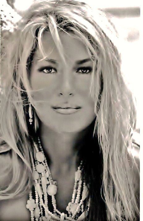 Black and white photo of a long blonde haired, possibly suntanned, highly attractive female face